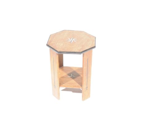 An octagonal hardwood plant standHaving an octagonal top with ebonised border and centred with an inlaid star raised on four 