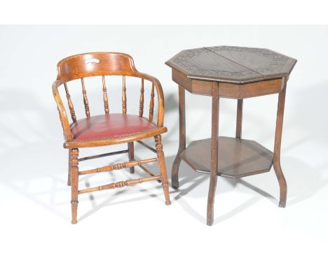 An early 20th Century oak Captain's chair and oak occasional tableThe Captain's chair with downswept arms supported on ring t