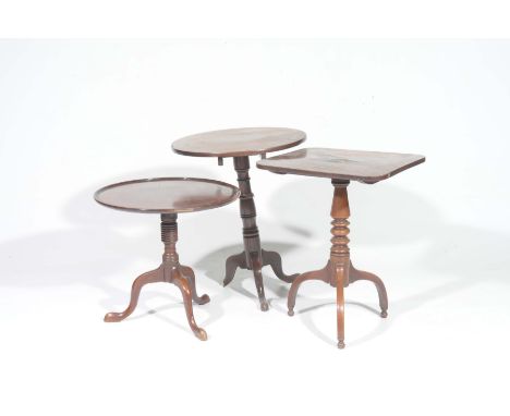 Three Georgian mahogany tripod tablesTo include a circular tray top example raised on ring turned shaft with three downswept 