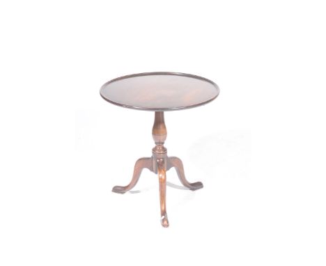 A Georgian mahogany tray top tripod tableThe circular top with a raised border supported on a ring turned baluster shaft with