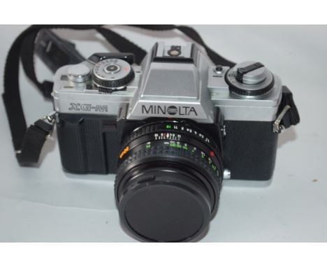 Minolta XG-M film camera together with Rokkor 50mm lens