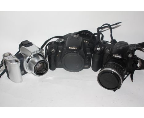 Canon 350 D body together with a Fujifilm S5200 and a Minolta Dimage