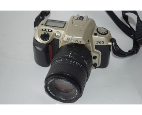 Nikon F60 film camera together with Sigma zoom 70-210mm lens, Nikon AF Nikkor 28-80mm lens and manual