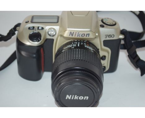 Nikon F60 film camera with film loaded, together with a Nikon AF Nikkor 35-80mm lens, manual and case