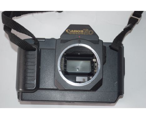 Canon T80 film camera together with Canon zoom lens, AC35-70mm plus manual