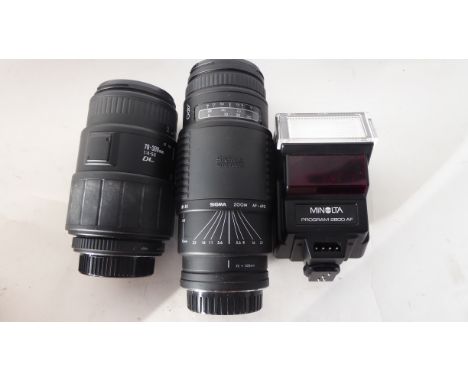 Sigma Zoom AF-APO 75-300mm lens together with a Sigma 70-300mm lens and a Minolta flash