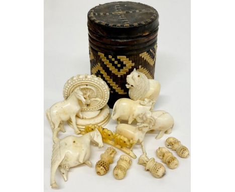 A selection of ivory animals in a vintage Rothmans tin 