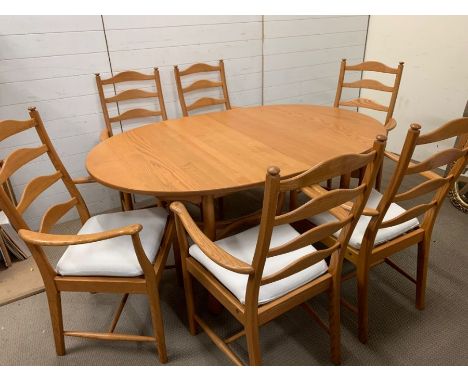 An Ercol dining table and six ladder back chairs 