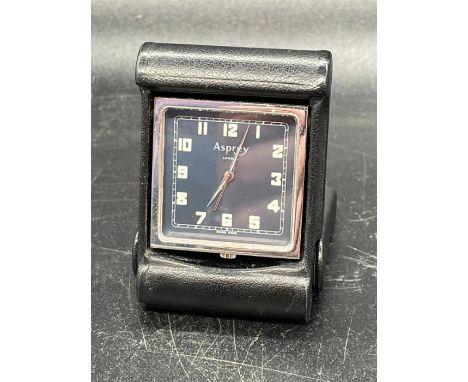An Asprey travel clock in Black leather holder.