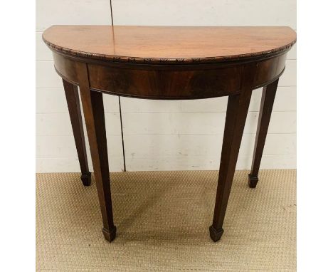 An 19th century mahogany Demi Lune fold over card table (78cm x 92cm)