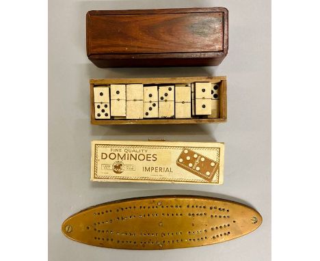 A selection of boxed dominoes and cribbage board 