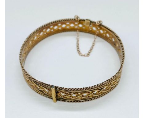 A 9ct gold bangle with safety chain (Total Weight 16.3g) 