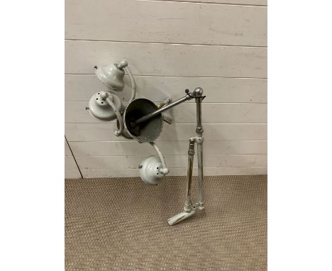 A four spot light painted brass industrial light arm. 