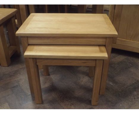 A nest of 2 new heavy light oak coffee tables