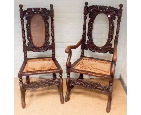 A Victorian heavy carved dark oak bobbin turned carver chair with cane panelled seat and back panel together with 1 matching 