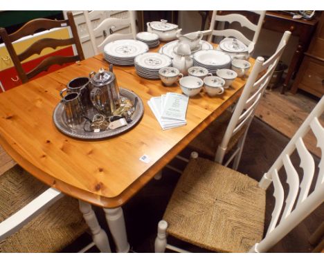 A modern pine and white extending dining table together with 6 ladder back chairs comprising 4 standards, 2 carvers, 1 still 