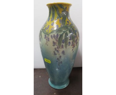 A Royal Doulton vase, decorated with trailing flowers to a yellow and green ground, with drill hole for table lamp conversion