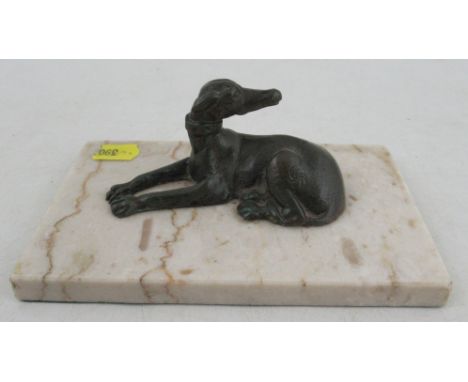 A metal&nbsp; model, of a recumbant dog, on marble base, height 2ins