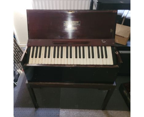 A Dulcitone keyboard instrument in mahogany case, by Thomas Machell & Sons, supplied by Moore and Moore with ivorine and ebon