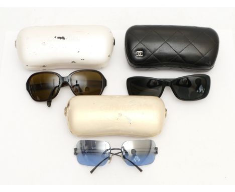 Three pairs of Chanel sunglasses, to include, a pair of black frames with 3D floral appliques, serial no. 5186 501 3F 57 16, 