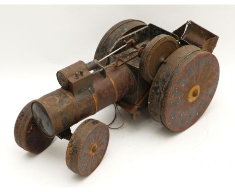 A tinplate steam engine/roller toy, circa 1930s,lithographed main body in red, black and yellow, playworn, 52cm long.