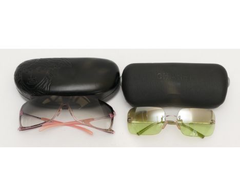 Two pairs of designer sunglasses, to include, a pair of Versace glasses with pink arms, serial no. 2048 1115 8G 120, cased, a