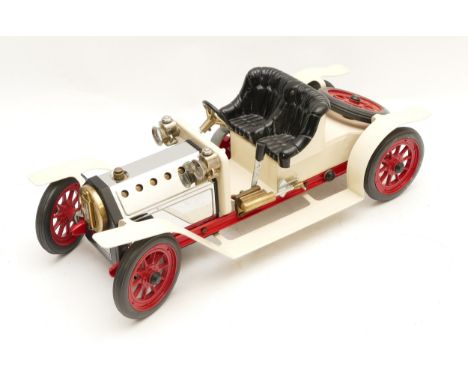 A Mamod live steam roadster car with white body, black seat and red spoked wheels, with burner, unfired in unused condition, 