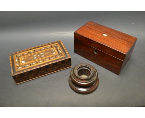 A red marble circular inkwell;  a rectangular rosewood tea caddy with mother of pearl inlay;  a wooden and mother of pearl ma