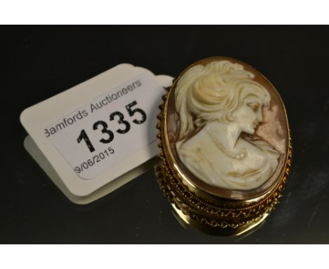 A Neoclassical Cameo portrait brooch, as a maiden, 9ct gold frame