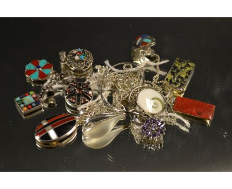 A multi-stone oval pendant inlaid with turquoise, lapis lazuli, etc;  a Shiva's eye shell pendant; a turquoise and carnelian 