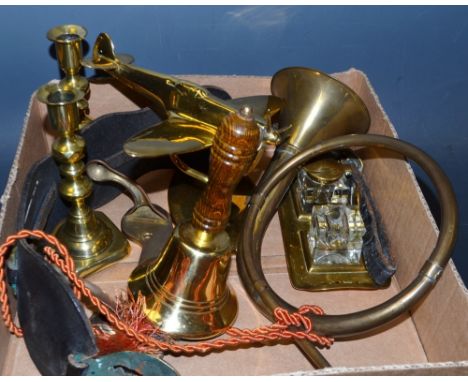 A brass model spitfire desk weight; an Art Nouveau brass desk stand; a brass hand bell; horse brasses; pair of candlesticks; 