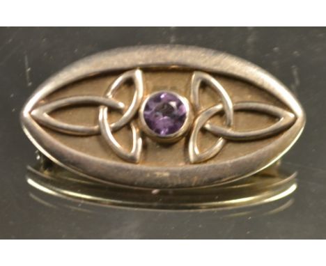 An Art Nouveau silver amethyst set brooch