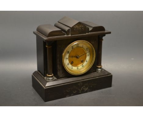 A late Victorian architectural slate mantel clock, the white enamel chapter ring painted with Arabic numerals, eight day move