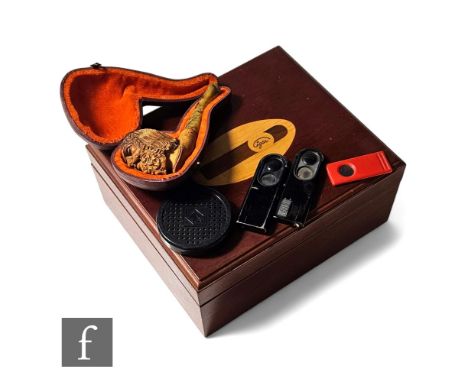 A 19th Century carved Meerschaum pipe in a later leather case and a marquetry inlaid humidor with cigar detail to the top, wi