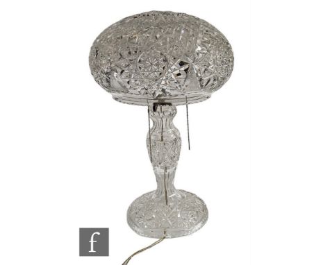 An early 20th Century clear cut glass table lamp with circular spread foot, baluster column and mushroom domed shade, height 