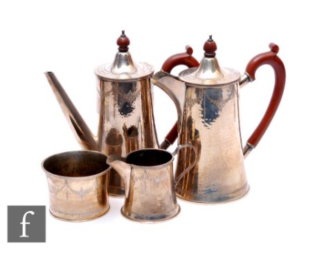 A silver four-piece tea service, to include teapot, coffee pot, milk jug, sugar with hammered design and engraved floral swag