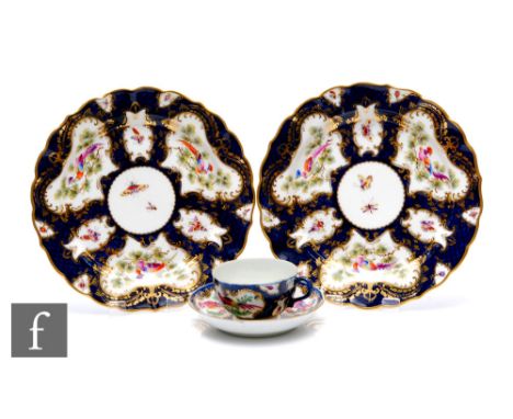 A late 18th Century Worcester blue scale ground teacup and saucer,&nbsp;with hand painted cartouche panels depicting stylised