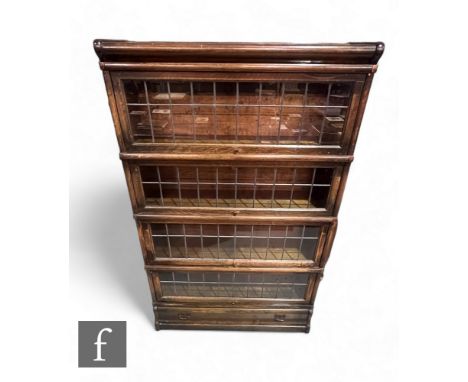 A pair of oak Globe Wernicke leaded light four sectional glazed bookcases on drawer plinth bases, height 145cm x depth 27cm x