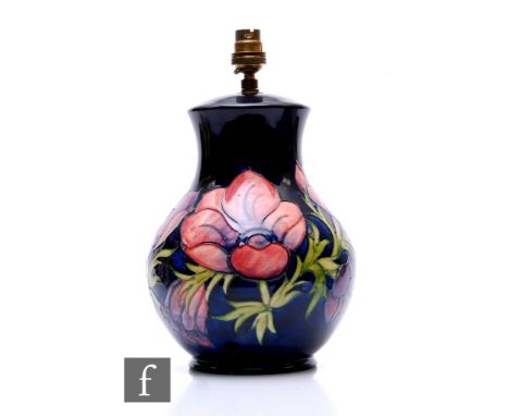 A Moorcroft table lamp base decorated in the Anemone pattern against a blue ground, impressed marks, height 32cm including fi