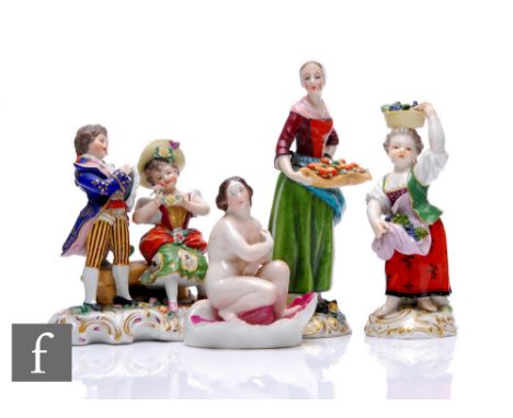A collection of 19th Century figures, including a Meissen figure of a grape picker, modelled as a child carrying grapes, on r
