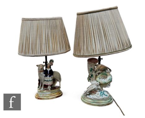 An early 19th Century Staffordshire spill vase, modelled as two nesting birds on tree stump base, mounted on wooden lamp base