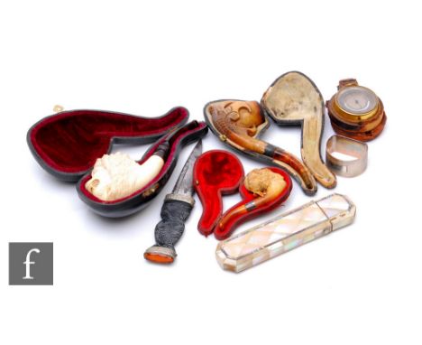 A 19th Century Meerschaum pipe in the form of a carved lion's head, another of an animal's claw, a lady's head, a pocket baro