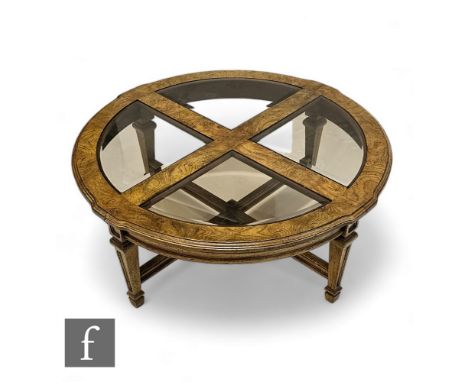 A 20th Century light figured walnut circular occasional table, shaped moulded edge top on tapering legs united by a swept str