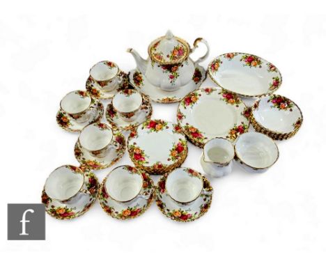 A mid 20th Century Royal Albert bone China tea service in the Old Country Roses pattern, comprising teapot, milk and sugar, s