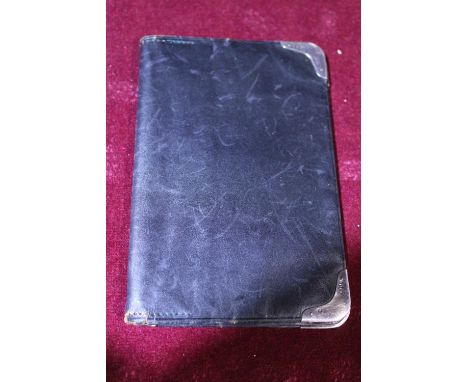 A vintage leather wallet with hallmarked silver corners 