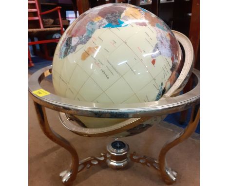 A mineral terrestrial globe in a brass coloured stand with compass uniting 3 lower stretchers. Location: RAB 