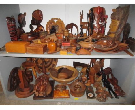 A wide selection of treen to include African carved tribal art wall masks and busts, various boxes and pots to include a Mauc