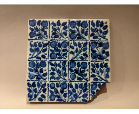 A William de Morgan Persian inspired blue tile with repeating floral patterns with impressed back stamp mark to the reverse f