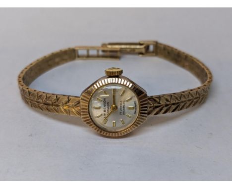 A 9ct gold vintage ladies J.W Benson manual wind wristwatch on a 9ct gold bracelet, 14.8gLocation: 