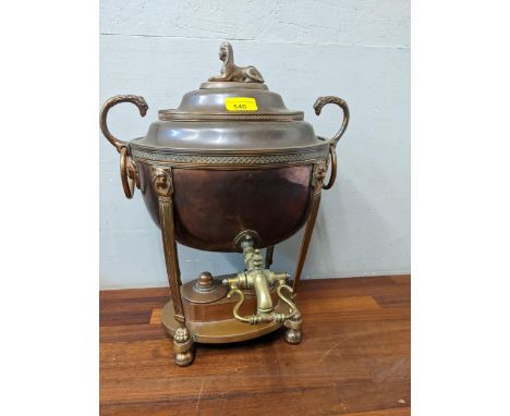 A Georgian copper tea urn with a domed lid and sphinx finial, lion mask ring handles and double burned on bull feetLocation: 